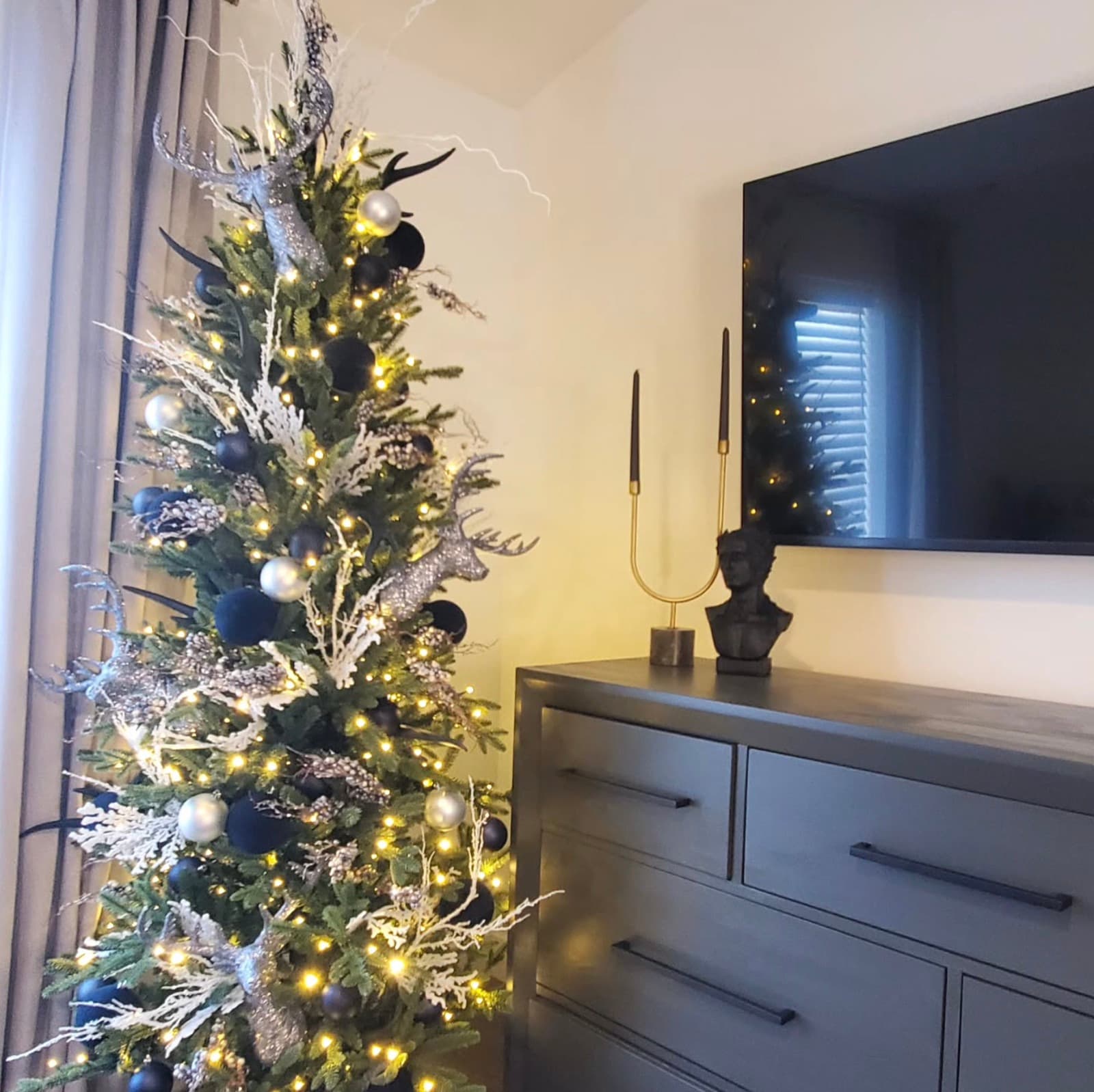Bedroom Christmas tree in navy and silver with glittering reindeer accents